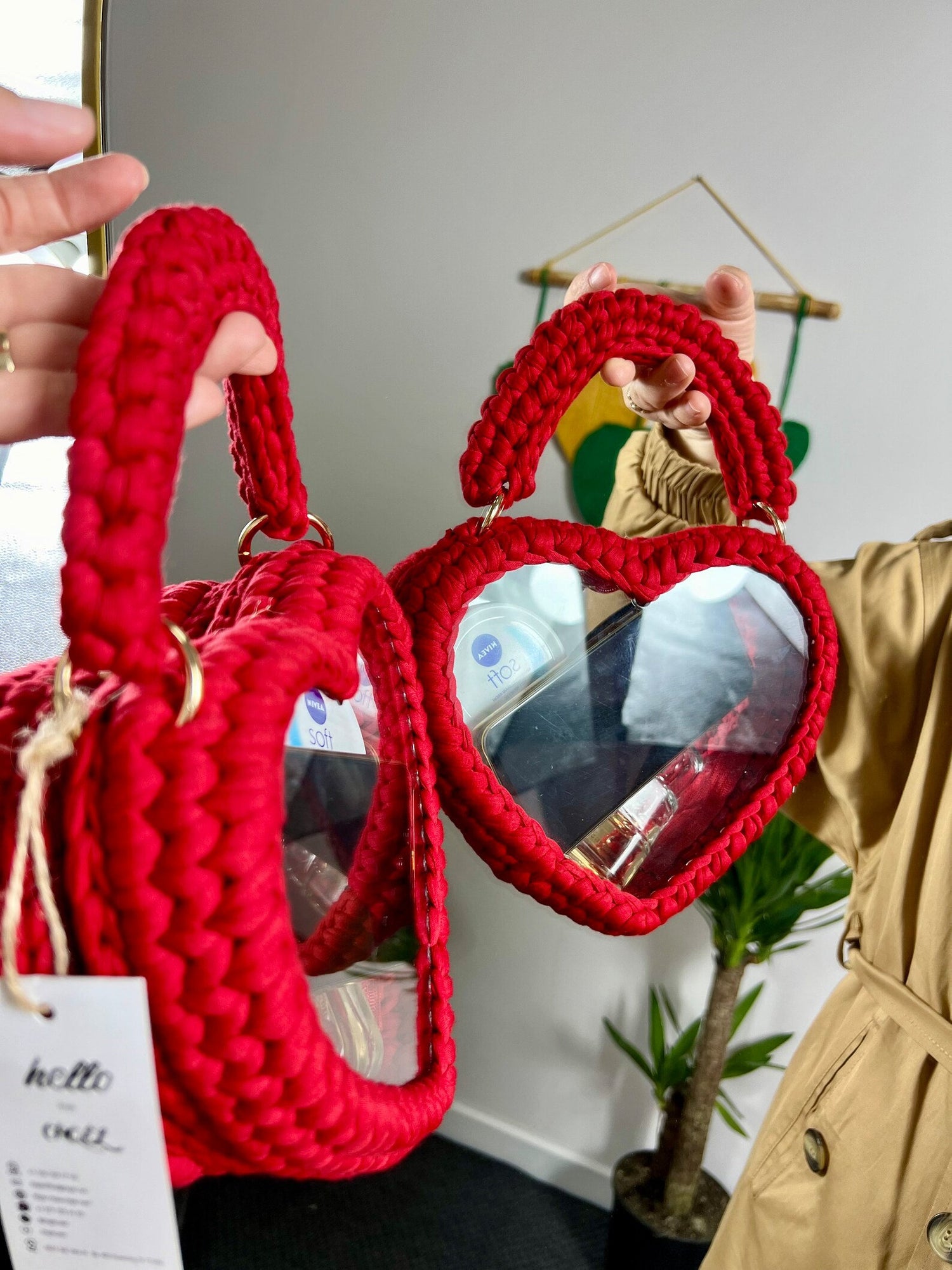 Exquisite Handmade Heart Transparent Red Crochet Clutch in use on women hand